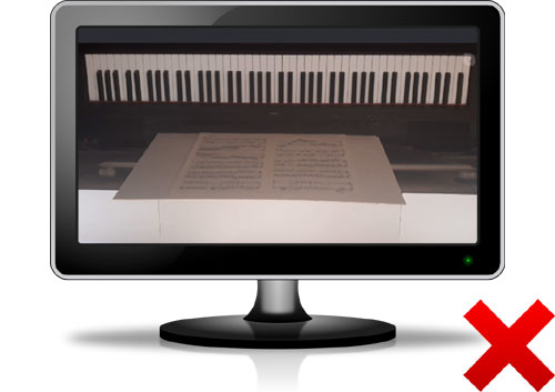 Overhead photo of upside down piano keyboard on a PC monitor